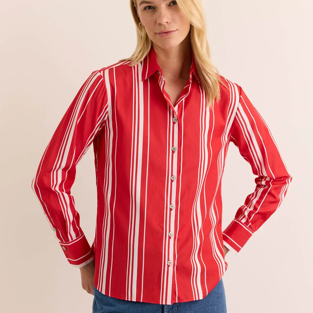 Woman wearing a red and white striped shirt against a beige background
