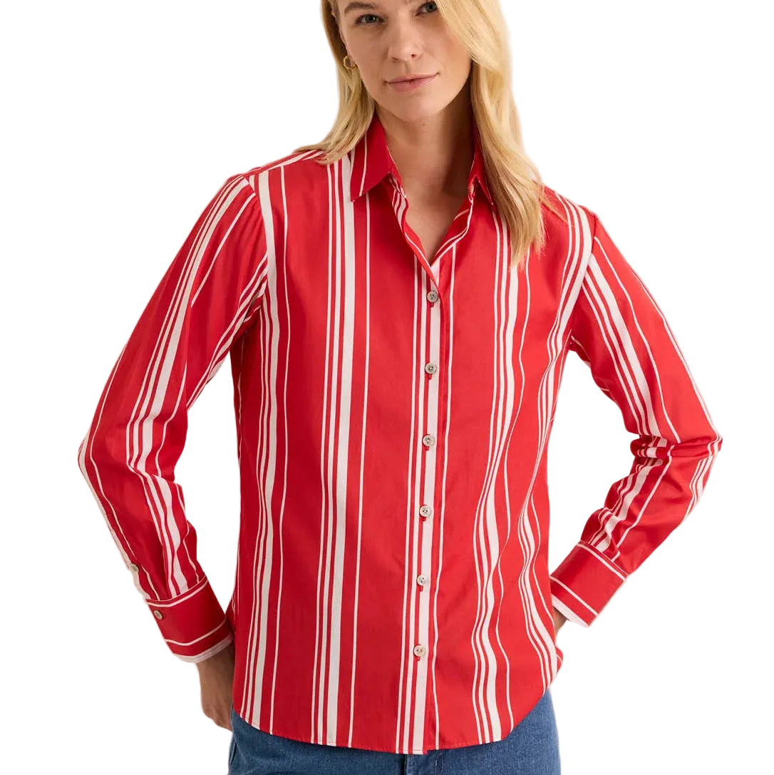 Woman wearing a red and white striped shirt against a beige background