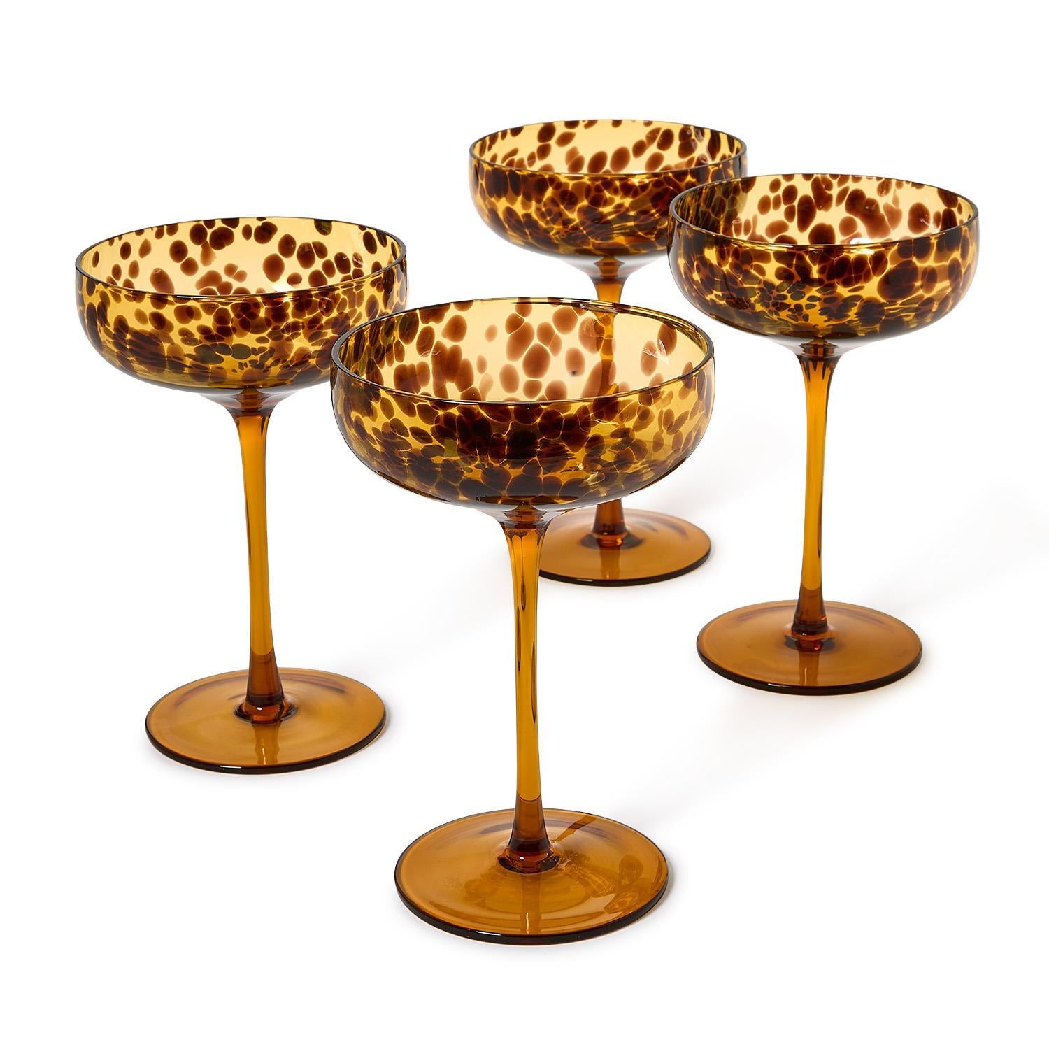 Set includes 4 coupe glasses with 8 oz. capacityUnique tortoise designHand-blown glass craftmanshipEach piece features unique color and pattern variationsHand wash only to preserve finish and detailing
