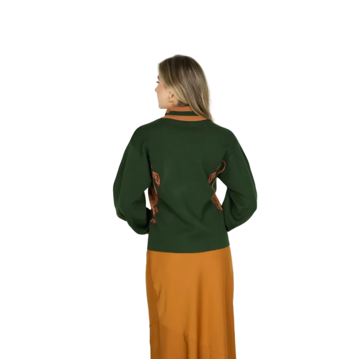 A woman shown from the back wearing a dark green knit sweater with brown leather-like trim details and a matching rust-orange skirt, photographed against a plain light gray studio background.