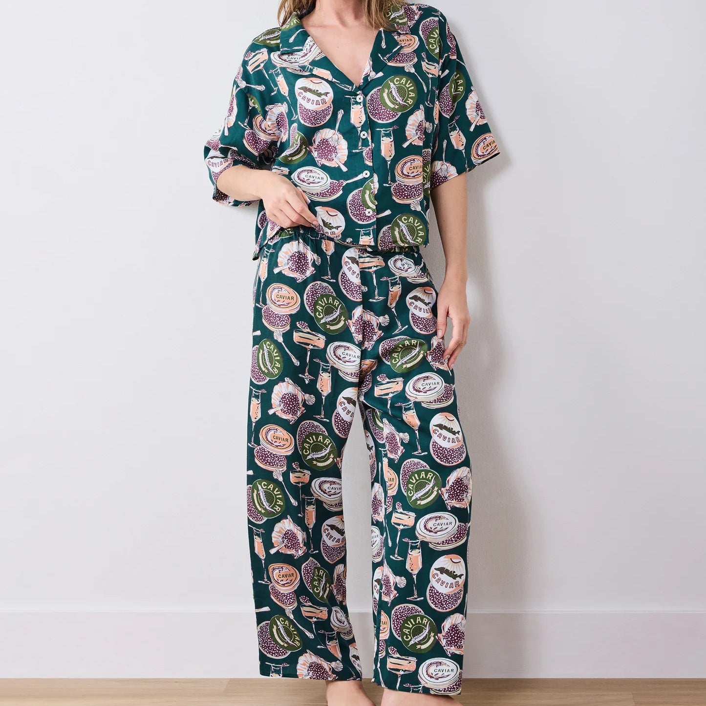 Woman wearing a floral pajama set against a white background