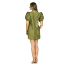 A woman modeling a short olive green dress with puff sleeves and a textured, perforated pattern, set against a plain white background.