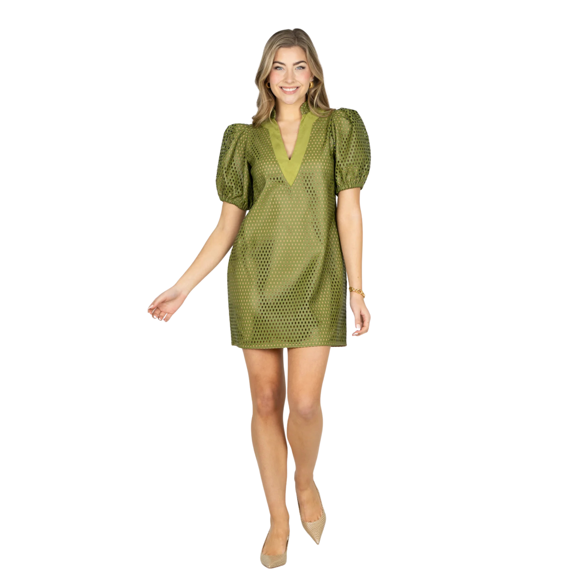 A woman modeling a short olive green dress with puff sleeves and a textured, perforated pattern, set against a plain white background.