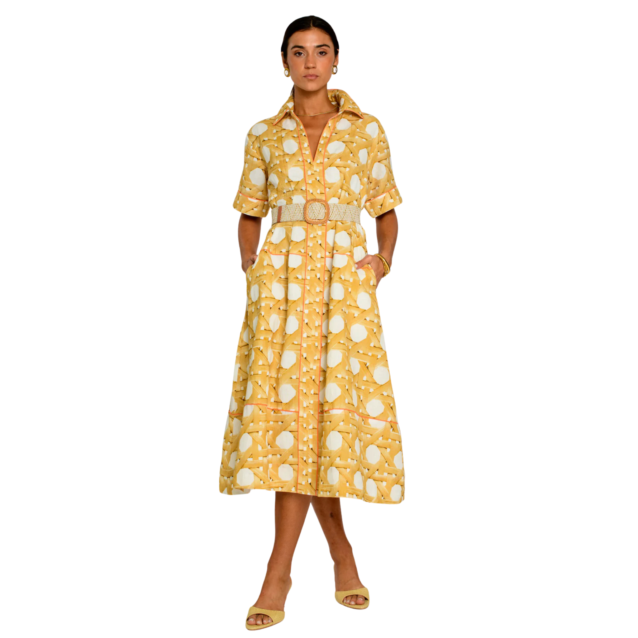 A woman modeling a yellow and white patterned midi shirt dress with a matching belt, standing against a plain white background.