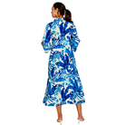 Woman wearing a blue and white floral dress on a white background