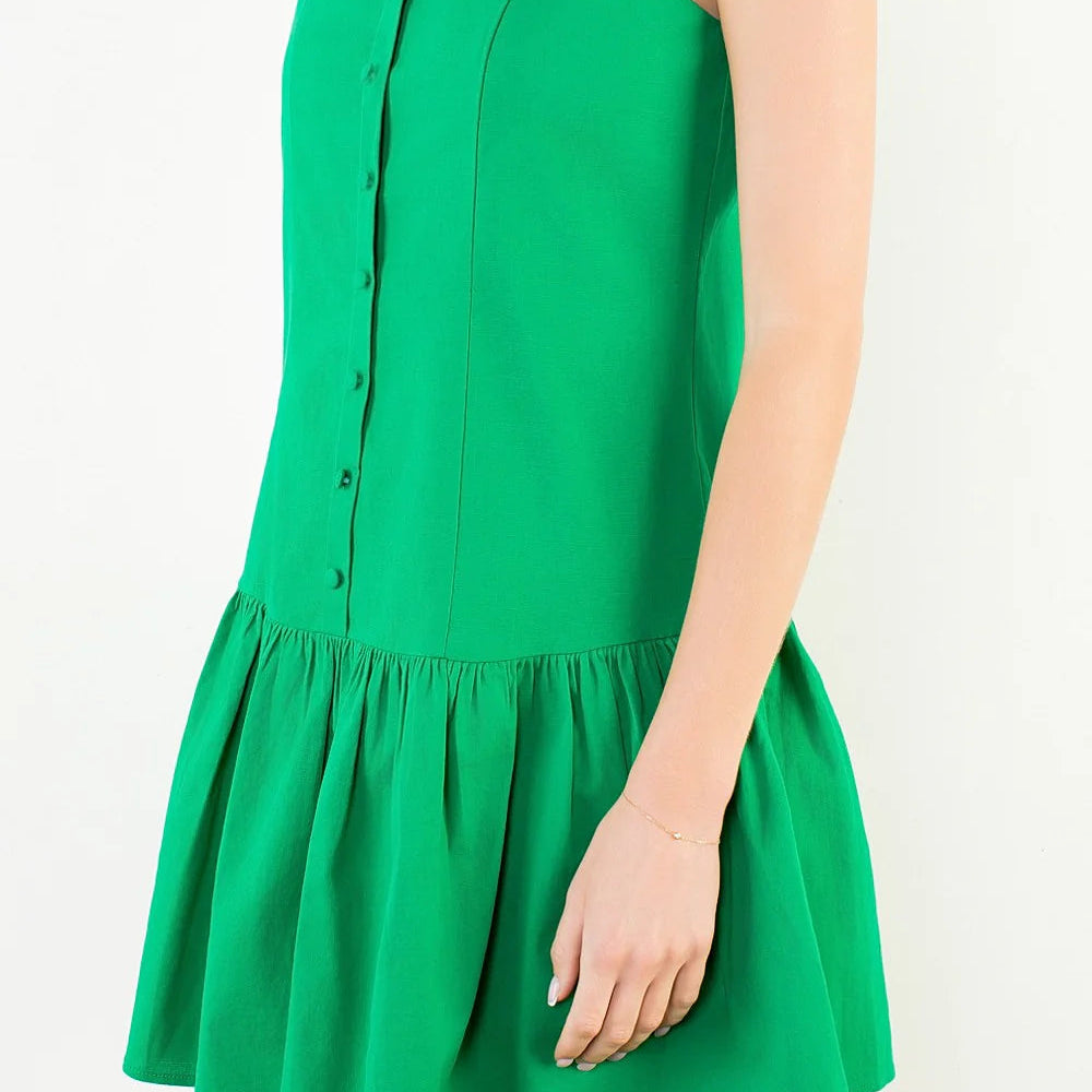 Green dress worn by a person on a white background