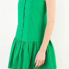 Green dress worn by a person on a white background