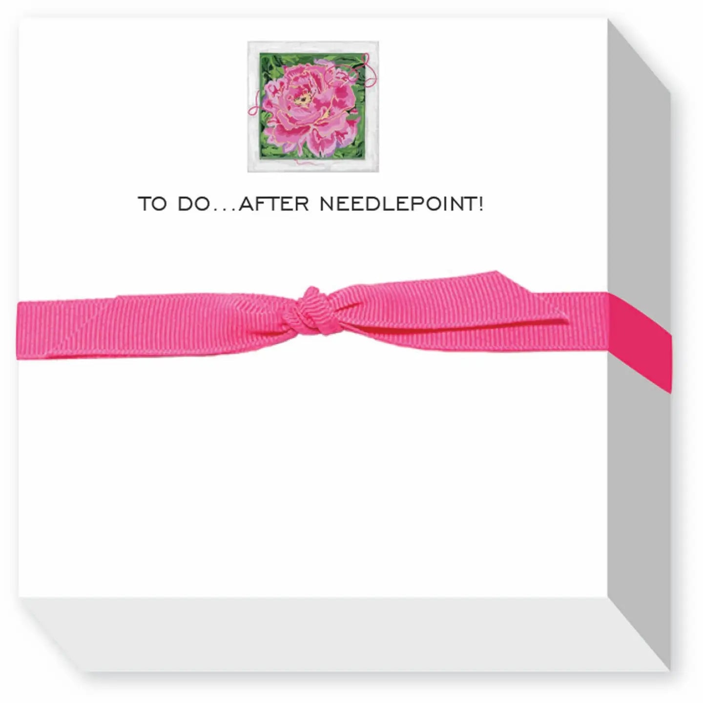 White box with pink ribbon and a small card with pink flower design on a white background
