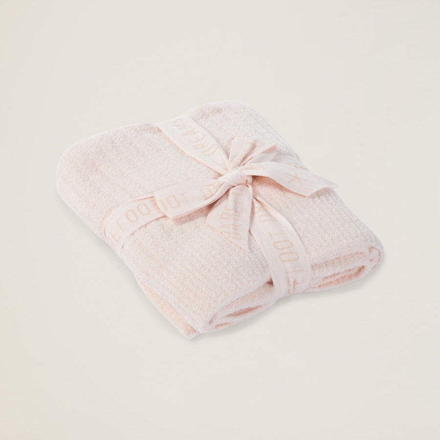 Pink towel with a knot on a light beige background