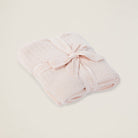 Pink towel with a knot on a light beige background