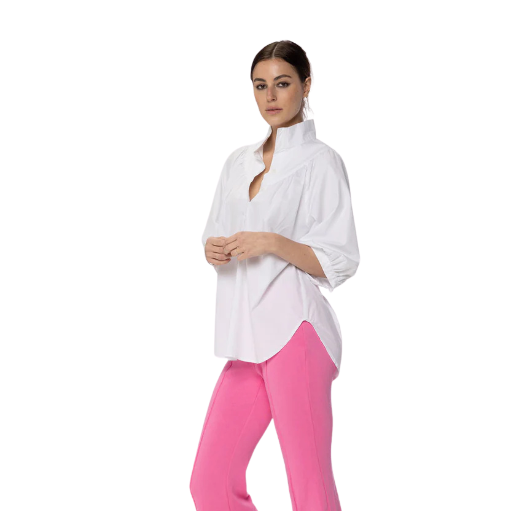 Woman wearing a white blouse and pink pants on a white background