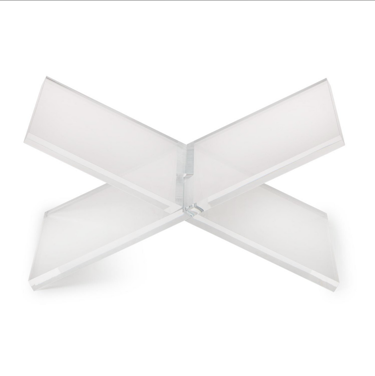 A modern, minimalist X-shaped acrylic or glass tabletop lamp shade on a solid white background.