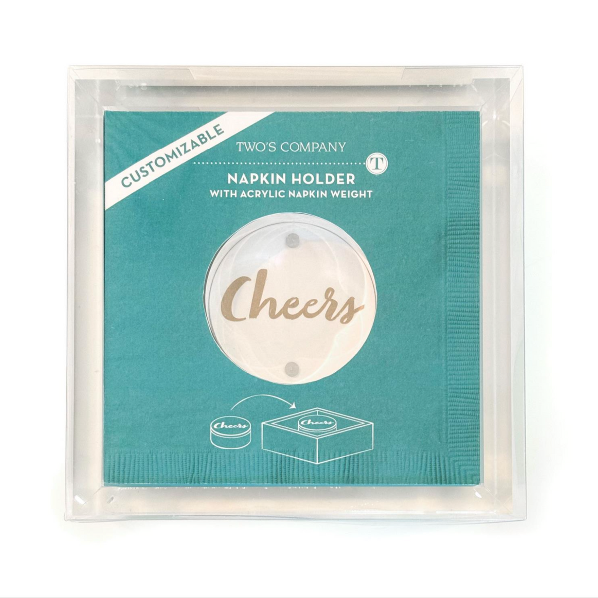 A packaged Two's Company napkin holder with acrylic napkin weight, shown in a clear plastic sleeve on a white background. The napkin holder insert is teal with a circular clear center and the word 'Cheers' in metallic gold script.