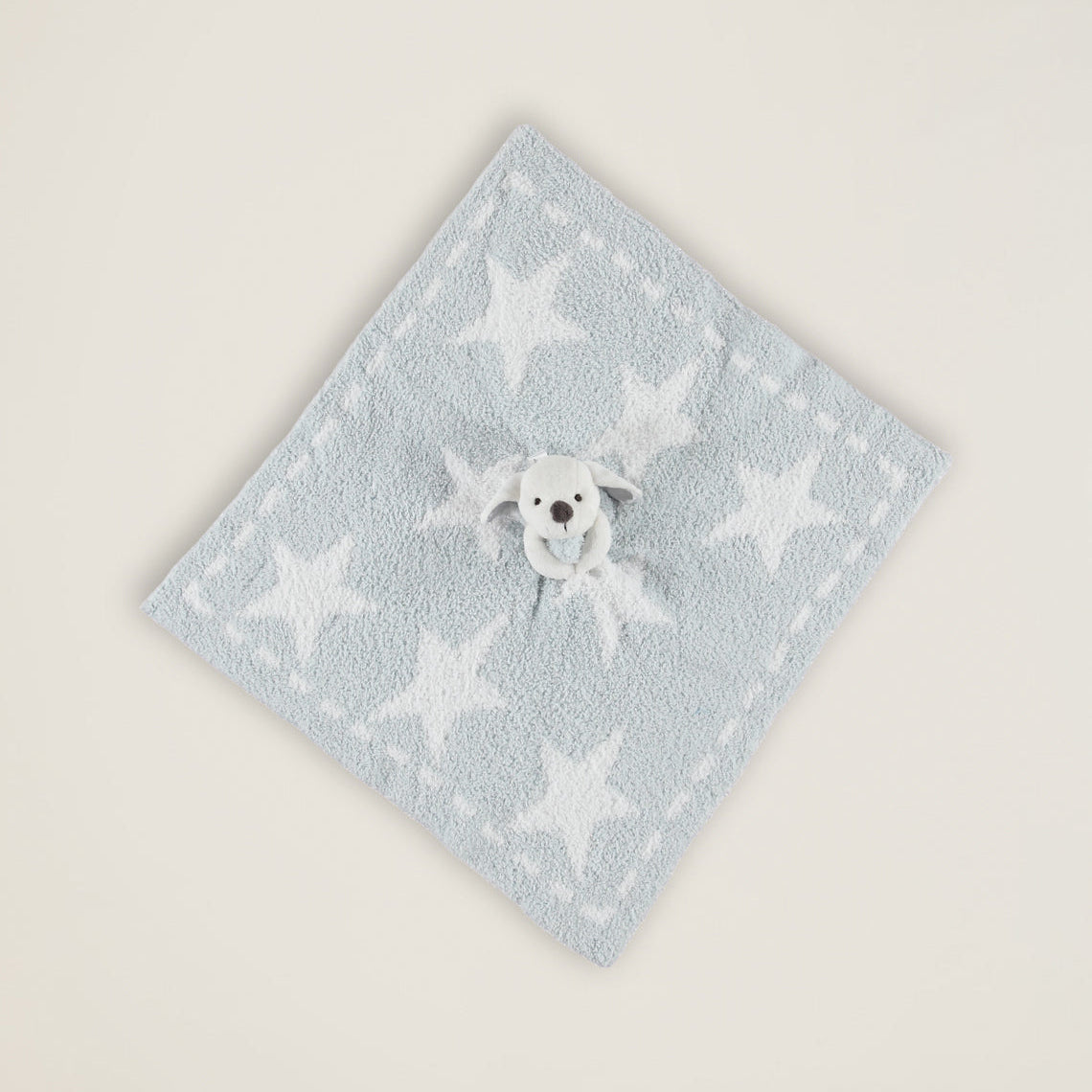 Light blue towel with white star pattern on a beige background