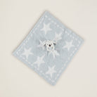 Light blue towel with white star pattern on a beige background