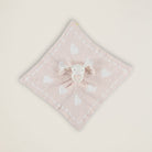 Pink towel with a cartoon character on a light beige background