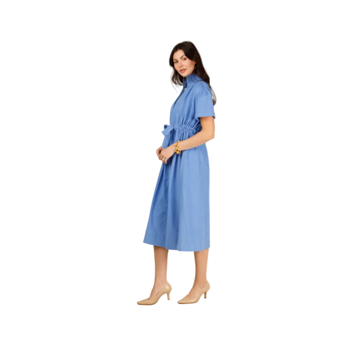 A woman modeling a short-sleeve blue midi dress with a gathered waist and tie detail, paired with beige high heels, against a plain light gray studio background.