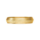 A wide, textured gold bangle bracelet with a ribbed, layered surface, shown against a plain white background.