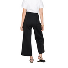 A model wearing black wide-leg cropped trousers with a white top and black pointed flats, shown from the waist down against a light gray studio background.