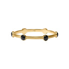 Gold bracelet with black stones on a white background