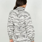 The Lolli Sweater in Wild Marble features a stand collar, notched neckline, and blouson sleeves finished with striped trim at the neckline and cuffs. The relaxed silhouette showcases our Wild Marble print, reimagining the marble veining found throughout Roman architecture as a tiger stripe motif in layered shades of grey. 