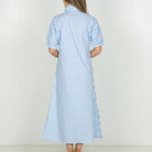 Woman wearing a blue and white striped dress on a white background