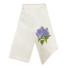 White towel with embroidered purple flower design on a white background