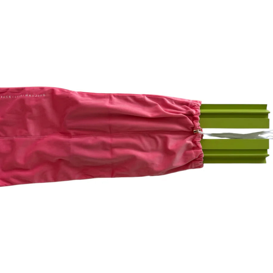 A pink drawstring storage bag with a white logo on the left side, shown partially open to reveal green aluminum poles extending out from the right side, on a solid white background.