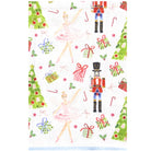 A white fabric item, likely a tea towel or handkerchief, featuring a festive Christmas print with ballerinas, nutcrackers, Christmas trees, candy canes, and wrapped gifts.