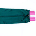 Green drawstring bag with pink ties on a white background