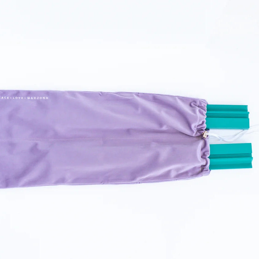 Purple drawstring bag with teal accents on a white background