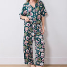 Woman wearing a floral pajama set against a white background