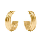 A pair of textured gold huggie hoop earrings with a ribbed, sculptural design, displayed on a clean white background with soft shadows.
