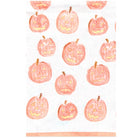 A white tea towel featuring a repeating pattern of hand-drawn orange jack-o'-lantern pumpkins with carved faces and small brown stems, finished with a peach-colored border at the bottom.