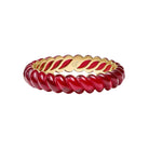 A gold-plated bangle bracelet with a twisted red enamel interior, shown on a clean white background.