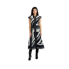 A woman modeling a sleeveless, midi-length black and white geometric patterned dress with a high collar and front zipper, paired with black knee-high boots, against a solid gray studio background.