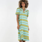 Woman wearing a blue and yellow striped dress on a white background