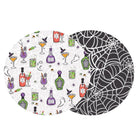 Two overlapping round coasters with a Halloween-themed pattern. The left coaster has a white background with a repeating pattern of purple potion bottles, green cauldrons, orange cocktails, ghosts, and candy.