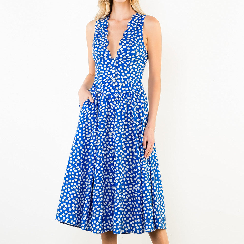 Woman wearing a blue and white patterned dress on a white background