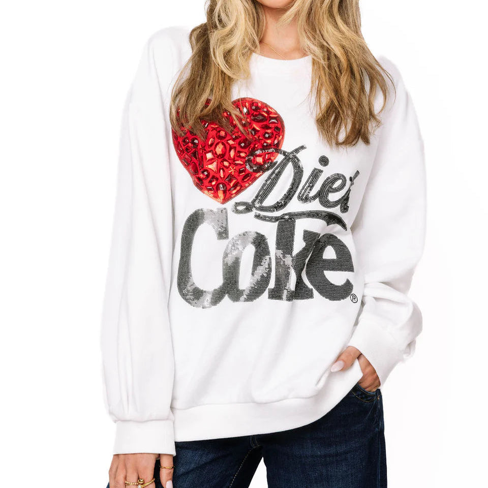 Woman wearing a white sweatshirt with a red heart and black text on a white background