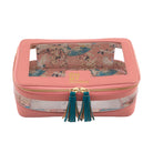 Pink jewelry box with floral design and green tassels on a white background