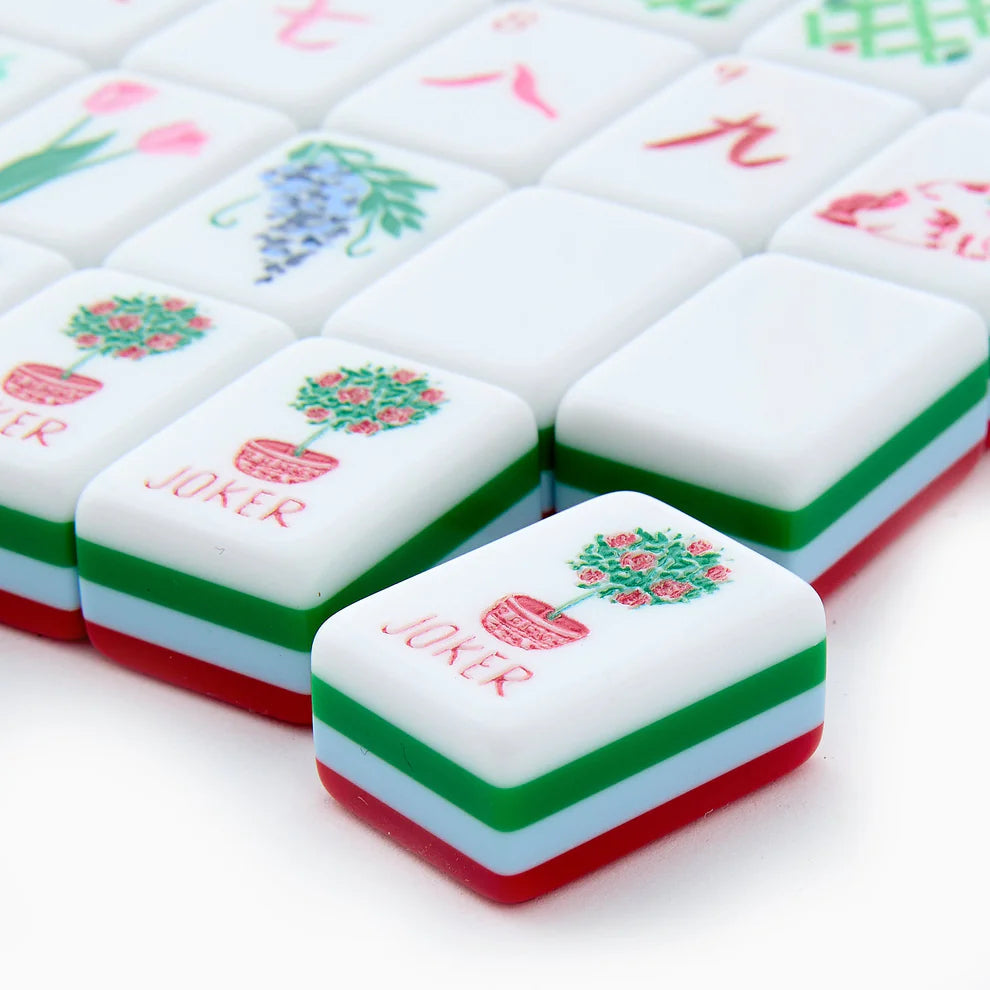 Close-up of colorful麻将 tiles with 'Joker' and floral designs on a white background