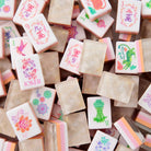 Collection of colorful stamp pads with various designs on a wooden surface