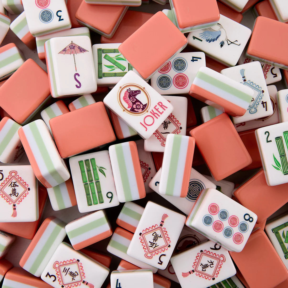Close-up of assorted mahjong tiles with various patterns and numbers.